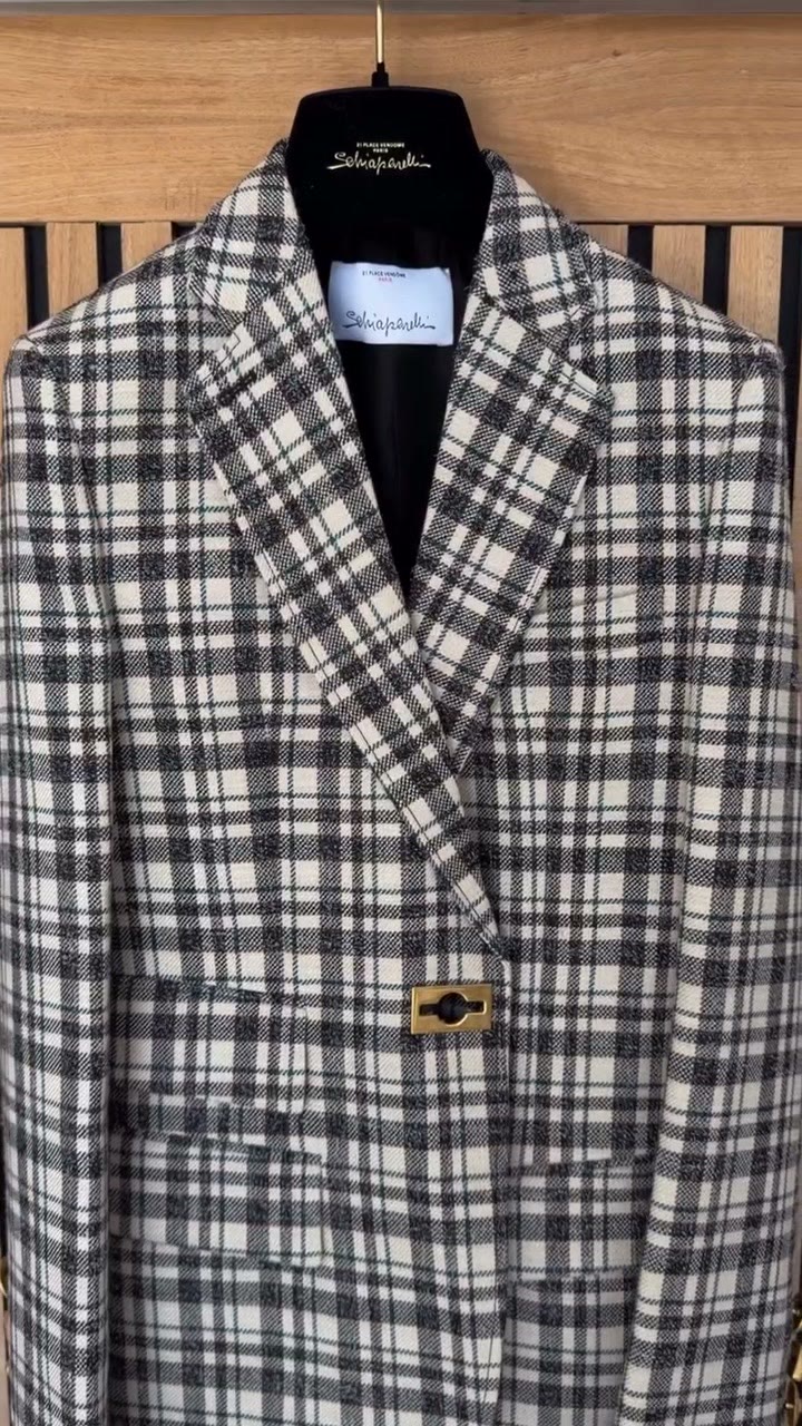 A Schiaparelli checked jacket on its hanger