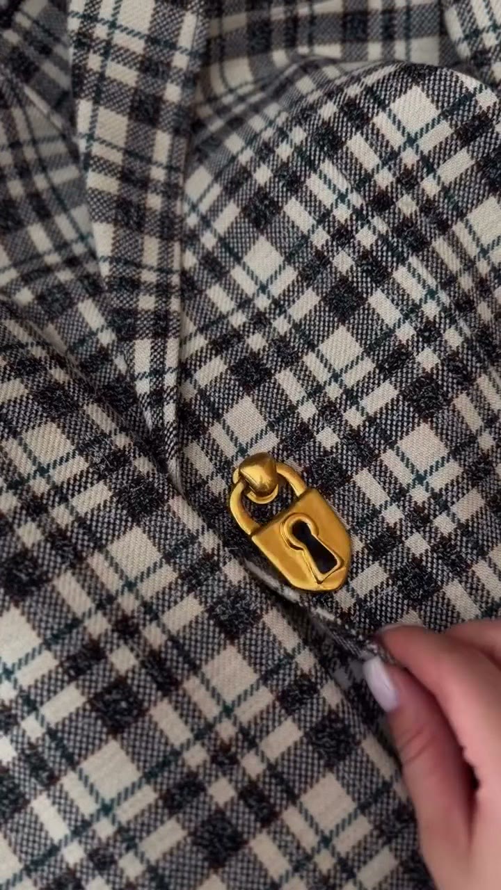 The jacket's gold padlock button